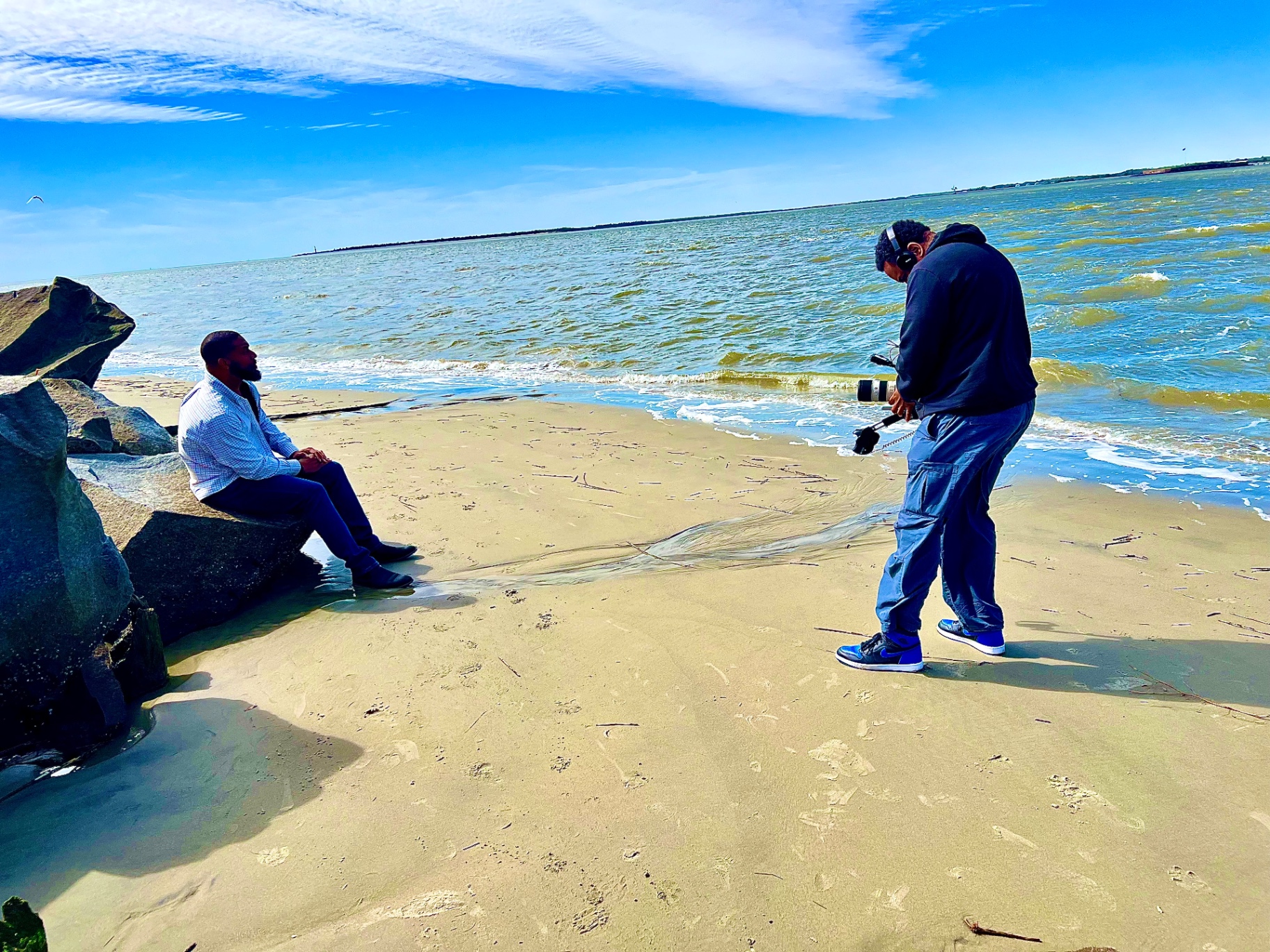 Jay Cameron being filmed on a beach during a production shoot