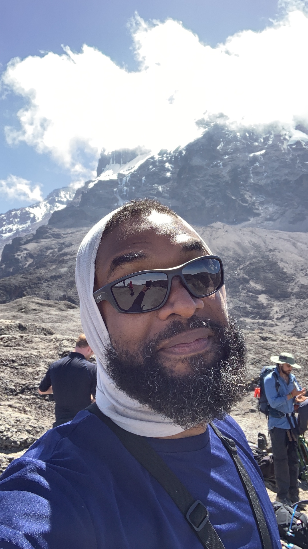 Jay Cameron high on Kilimanjaro with the glacier behind him