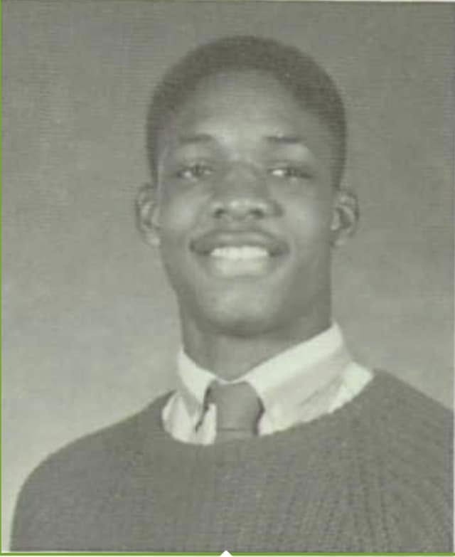 A young Jay Cameron in a school portrait wearing a sweater and tie