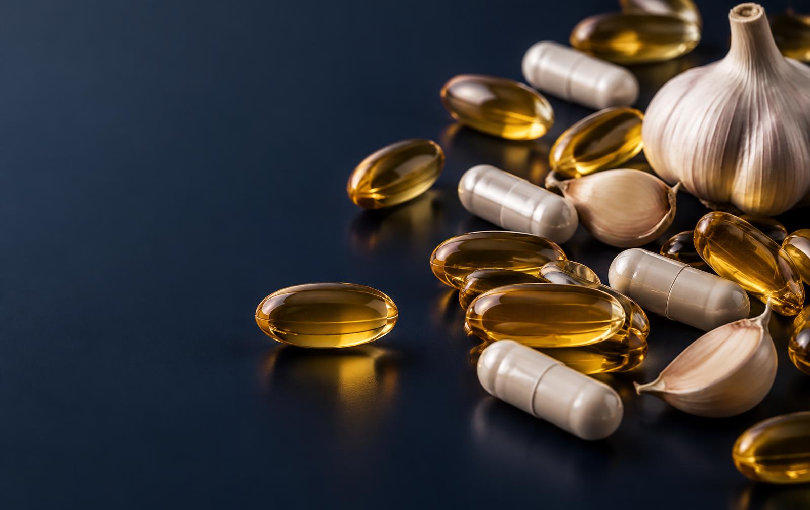 Omega-3 softgels, garlic capsules, and garlic cloves